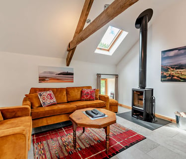 Your holiday cottage is fully equipped with a log burner and comfy seating.