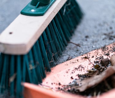 Broom sweeping debris