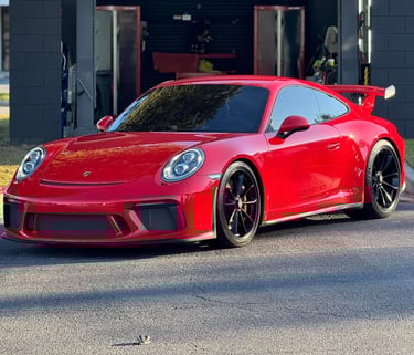 a red sports car parked in front of a building