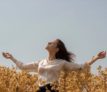 a woman with her arms outstretched up and arms outstretched out, she is standing in