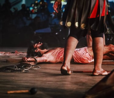 a man (Jesus) laid down on the floor beaten with blood on his body.
