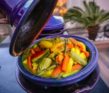 Vegetable tagine served from blue traditional Moroccan ceramic pot