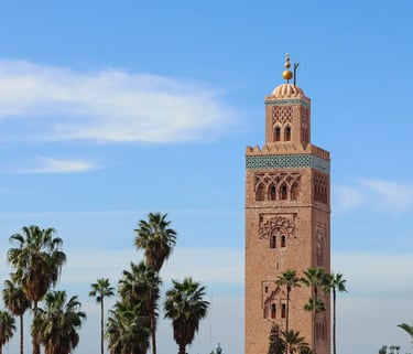 The famous Koutoubia Mosque tower in Marrakech, pictured against a blue sky