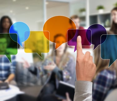 Person pointing at idea bubbles in a group, symbolizing communication and connection.