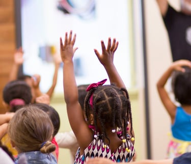 Child hands are raised in children's church.