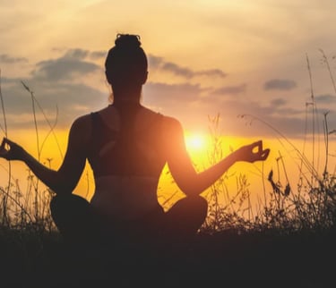 femme de dos en position de méditation en exterieur