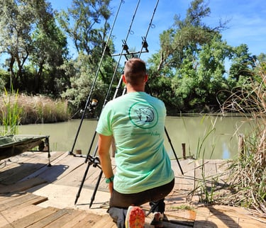 a man is fishing on a dock with a fishing rod