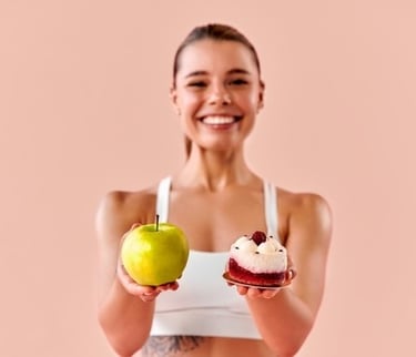 a woman holding a cake and a cupcake