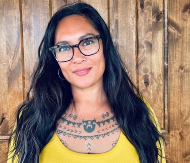 Portrait of death midwife Michelle Mondia in front of wood wall.