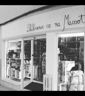 a store front of a store with a woman in a dress