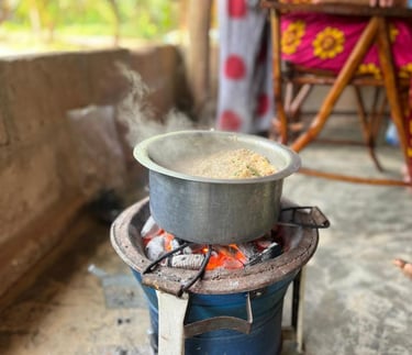 Traditional Zanzibari local food being cooked on a charcoal stove (jiko la mkaa) during a Zanzibar spice tour, showcasing