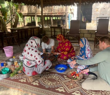 Family participating in a hands-on cooking class with a local guide during a luxury Zanzibar spice tour, learning traditional