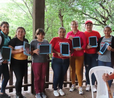 Teachers stand together in a line, presented with tablets.