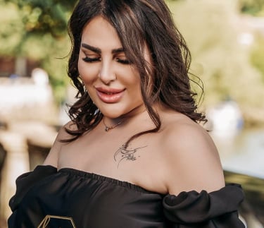 Model holding birthday cake in elegant black dress, captured by Fred Art Studio.