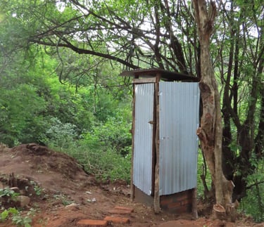 Outhouse in remote landscape used to increase hygiene and sanitation.