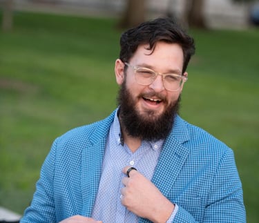 a bearded bearded man in a blue suit and tie