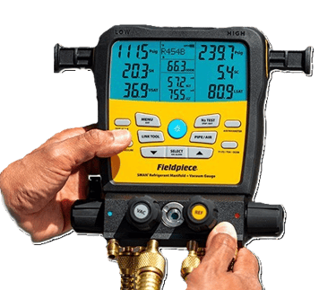 A technician holding a Fieldpiece SMAN digital refrigerant manifold gauge.