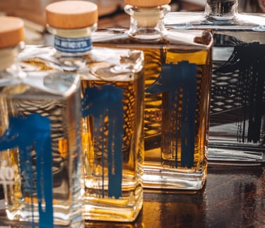 four bottles of uno tequila, uno blanco, uno reposado, uno añejo and uno cristalino