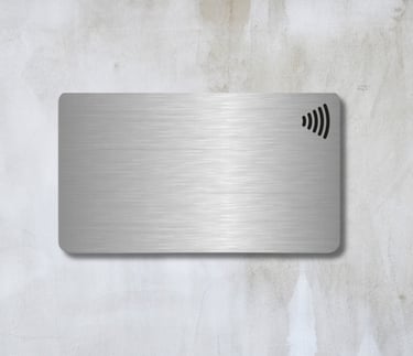 a metal NFC card with a wireless logo on top. made in paranaque