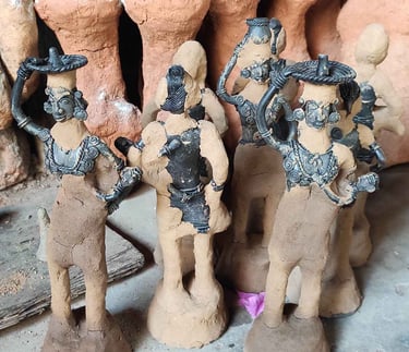 "Handcrafting tribal brass art: Layering fine clay over detailed wax mould in Bastar's Dhokra technique"