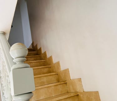 a staircase casement with a white wall and a white wall