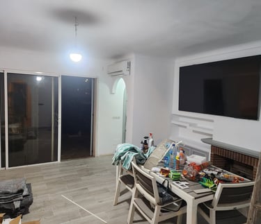 a living room with a television and a television