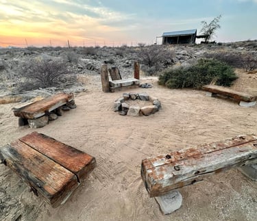 a boma with benches for a bonfire in the desert in uis namibia