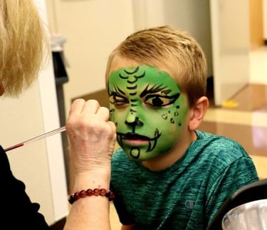 Birthday Boy Getting Face Painted by Doodad the Funny Las Vegas Kids Magician's Artist.