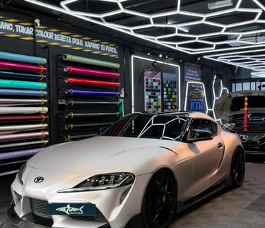 Toyota Supra wrapped in satin pearl white vinyl at One 7 Garage