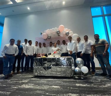 a group of men standing around a table with balloons