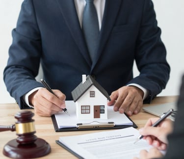 A lawyer reviewing property documents with clients in a bright office.