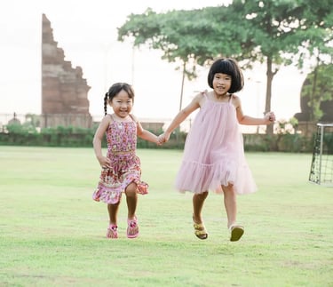 Children running together at Padma Resort Legian Bali during natural family photography session.