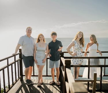 Family enjoying panoramic ocean views during a family photography session at AYANA Resort Bali