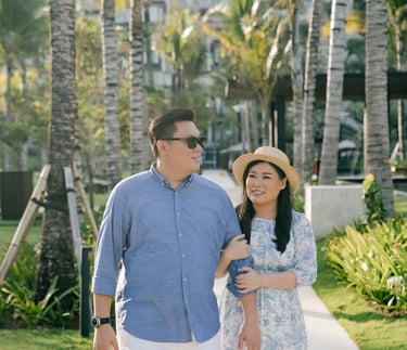 Mother and father walking together near the beach at The Apurva Kempinski Bali.