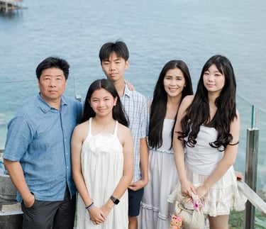 Family portrait on a scenic cliffside with ocean view at Ayana Resort Jimbaran Bali
