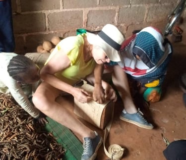 Tourist learning traditional basket knitting from local artisans during an authentic Zanzibar village tour
