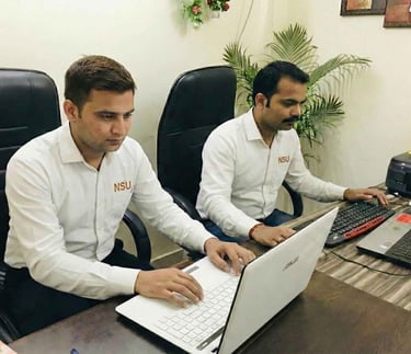 Professional security data operators from NSU India managing digital visitor records.