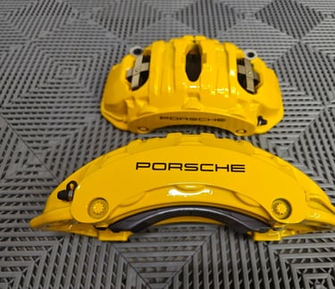 Porsche Macan GTS calipers with a color change from OEM Red paint to Signal Yellow powdercoat