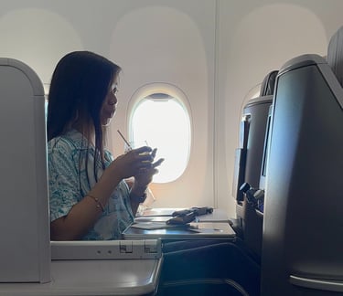 a lady drinking on a business class suite on singapore airlines