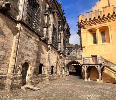 a stone building with a staircase going up the side of it