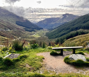 a bench overlooking the scenery in the mountains
