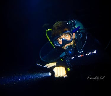 Experienced night diver exploring the vibrant marine life of Gili Trawangan after sunset with Gili Scuba Diving.