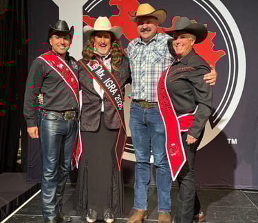 Four cowfolks standing on the Royalty stage. Three are in all black and one is in blue.