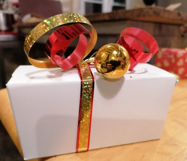 a gift box with a red ribbon tied to it