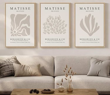 Three framed Matisse cut-out art prints hanging above a neutral beige sofa in a modern living room.