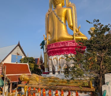 Giant golden Buddha statue and Reclining Buddha at Wat Khun Chan temple in Bangkok, Thailand.