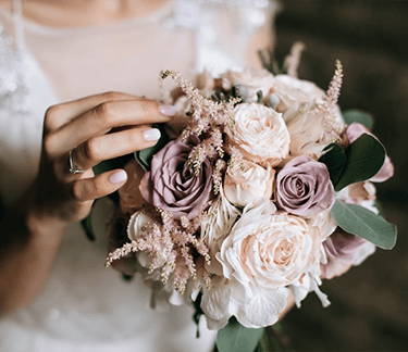 a woman in a wedding dress holding a bouquet