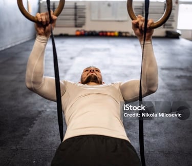 a man doing a pull up barbell in a gym