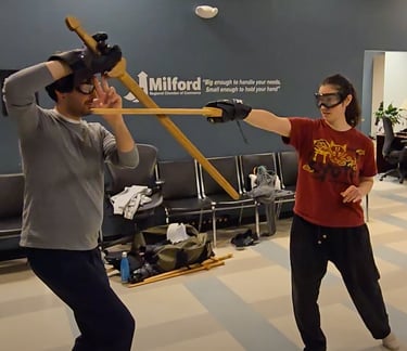 Two students in light free form sparring.