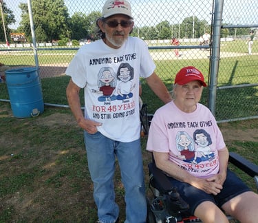 a man and woman in a wheelchair in a baseball game